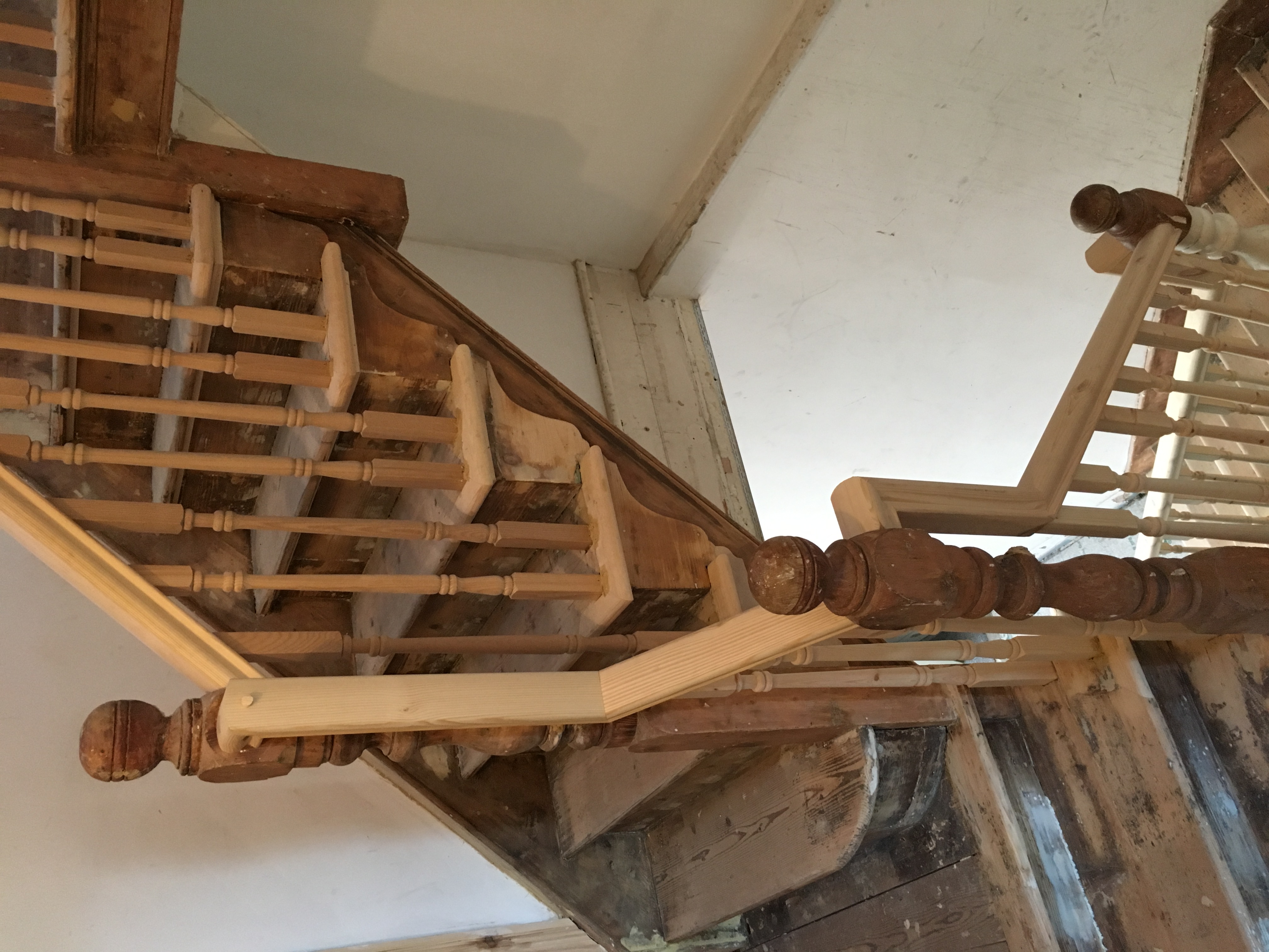 Bespoke swan-necked handrail with turned spindles and refurbished stair nosing's
