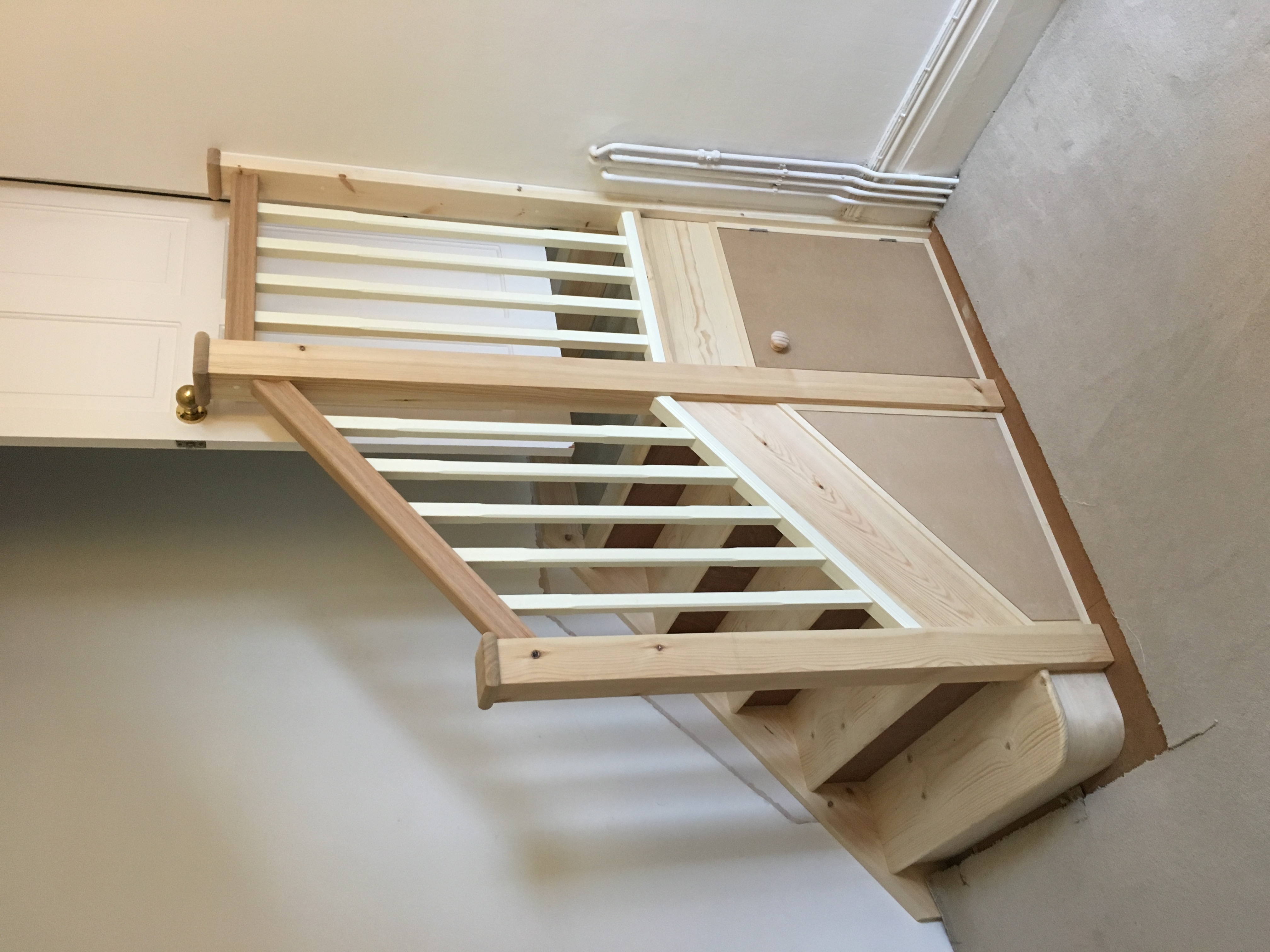Standard stair with oak handrail and understair cupboard