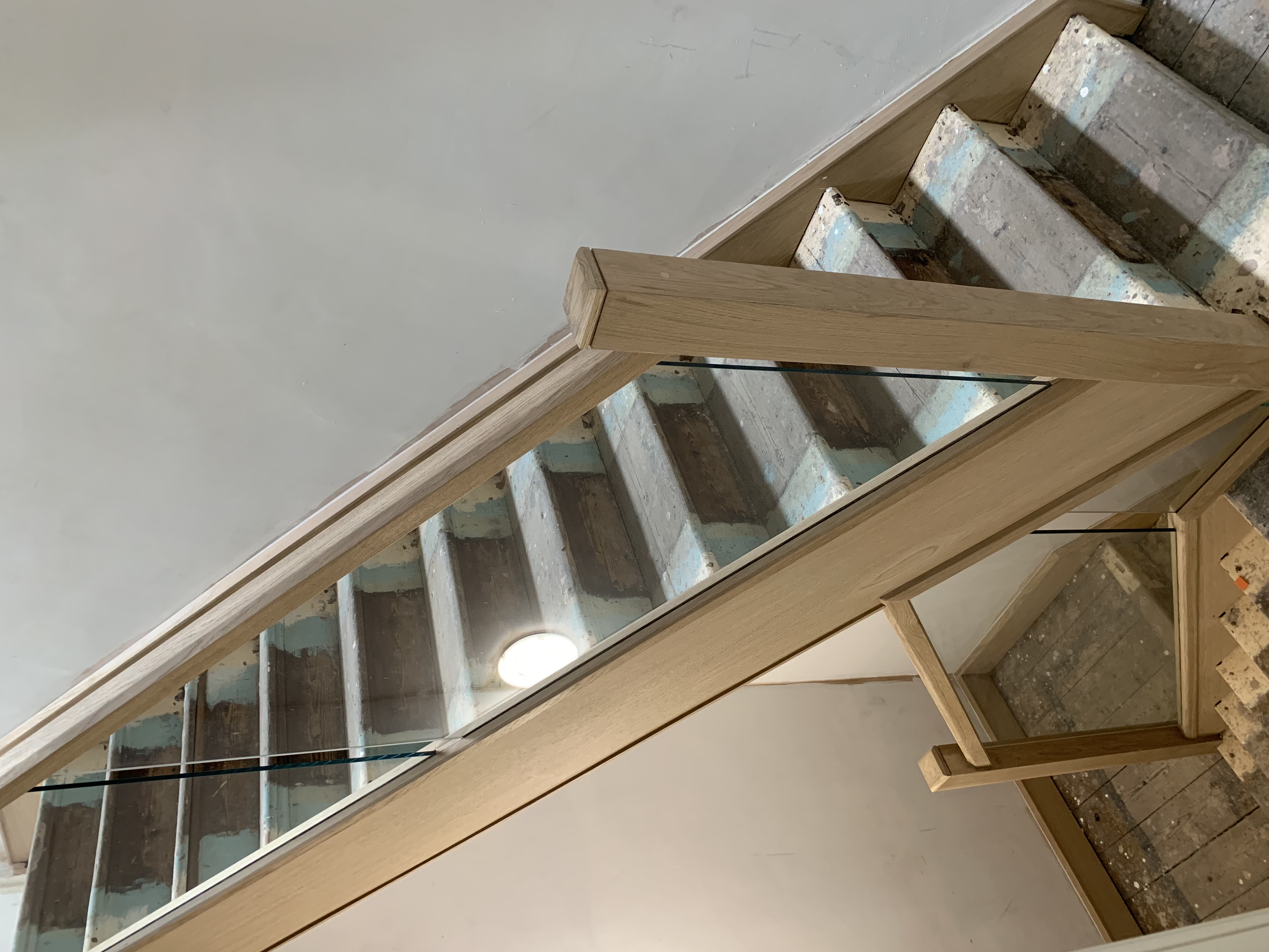 Oak cladded stair with oak and glass balustrade