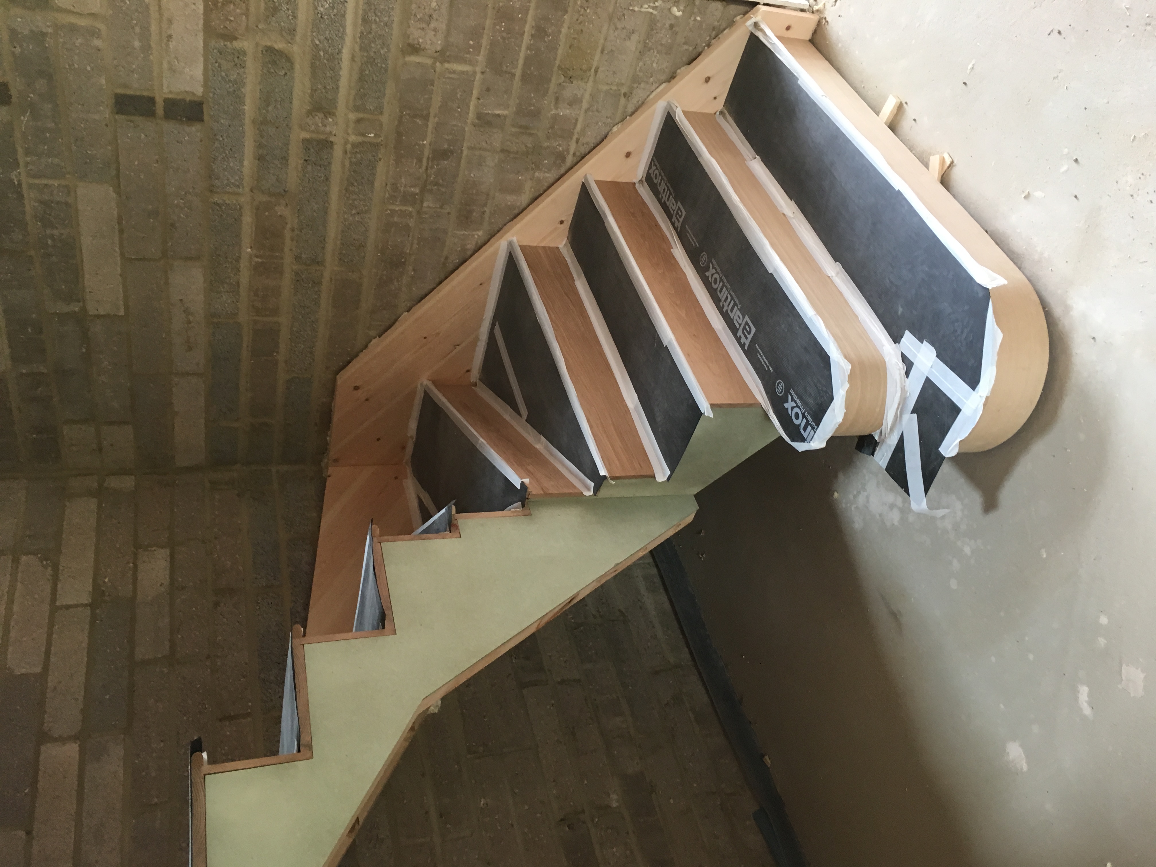 Oak tread and rise cut string staircase with double curtail treads