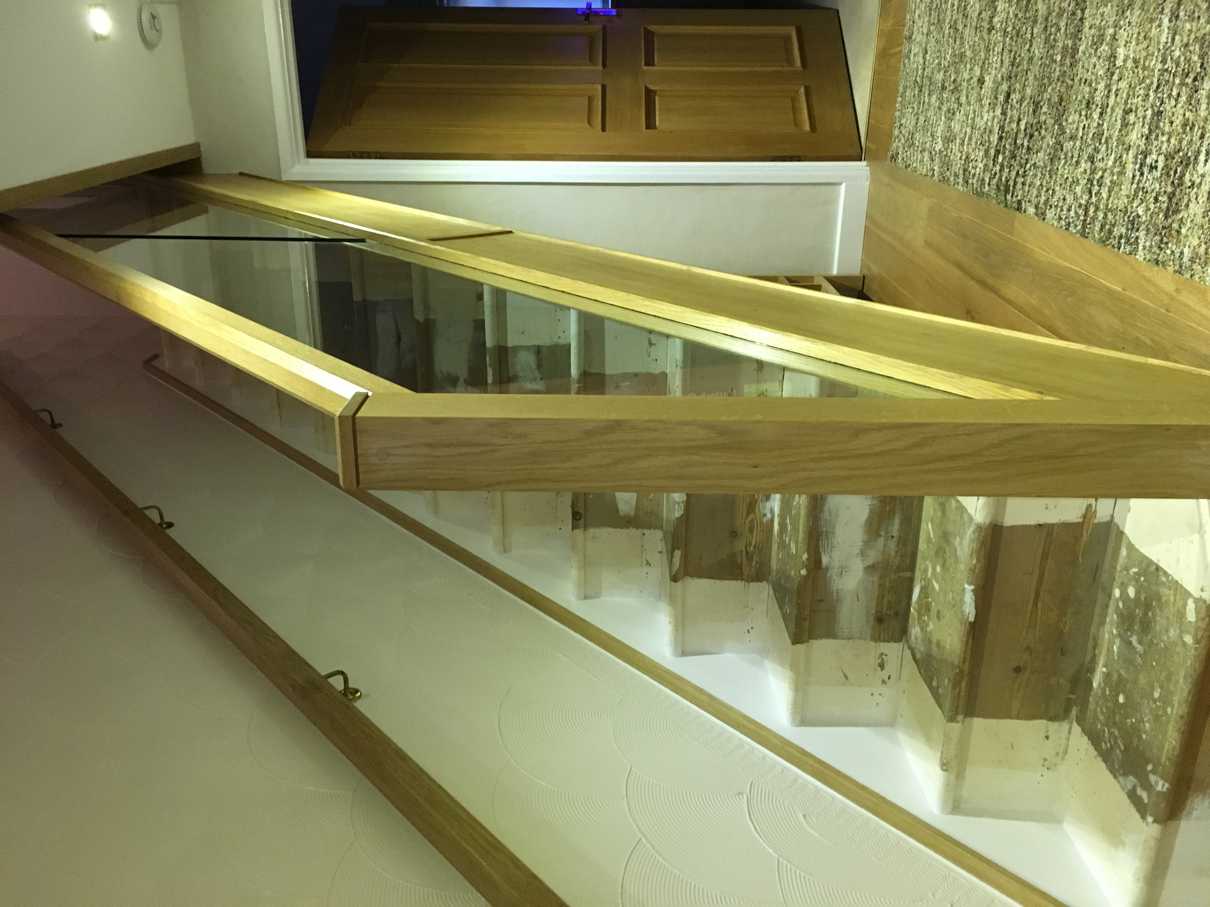 Oak cladded stair with oak and glass balustrade