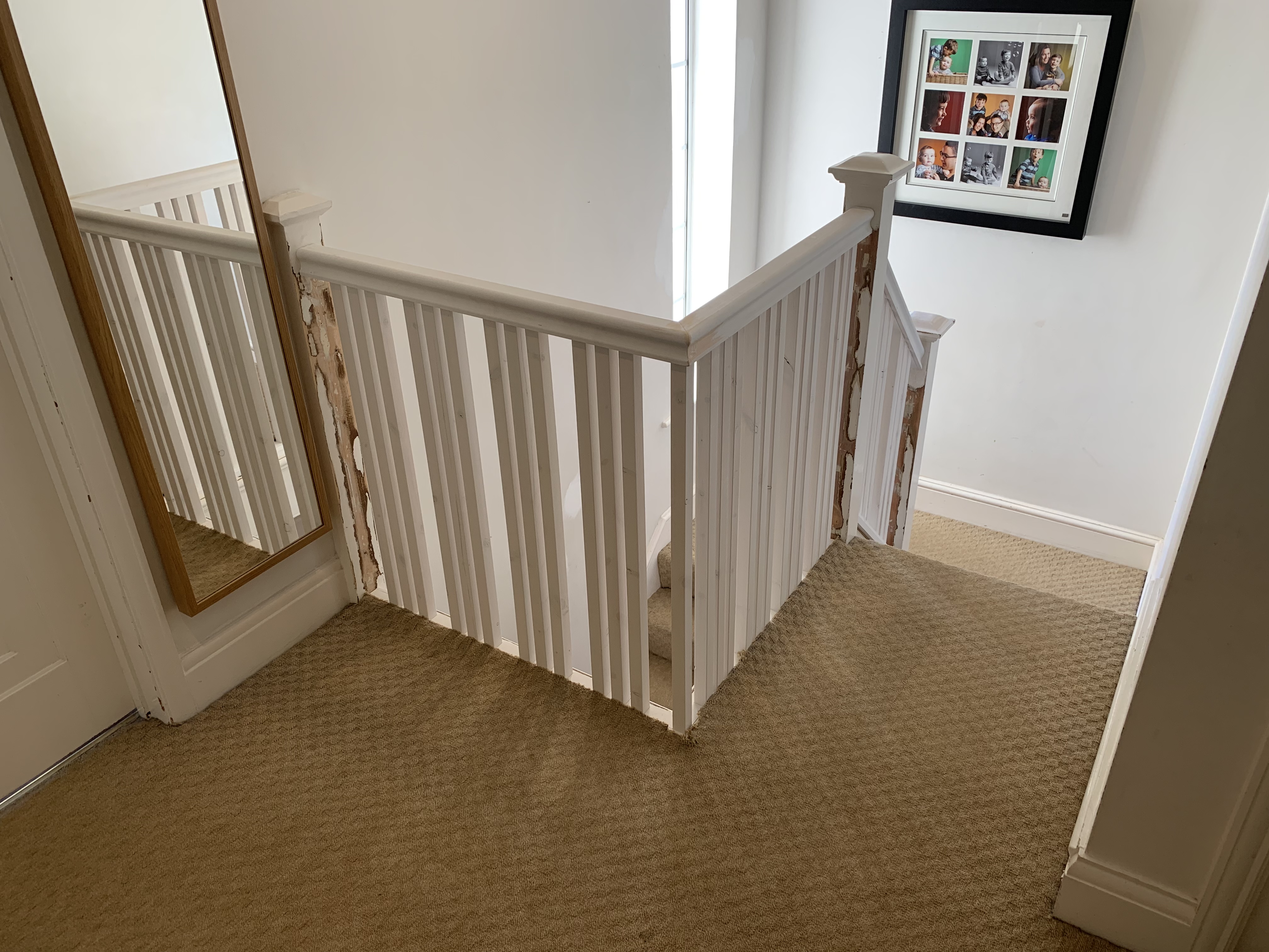 Primed handrail with primed spindles grouped in 3s