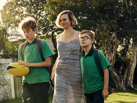 mom and two sons walking to school