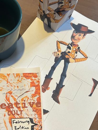 A printed copy of our downloadable magazine and a Woody from Toystory cube that you can print and make