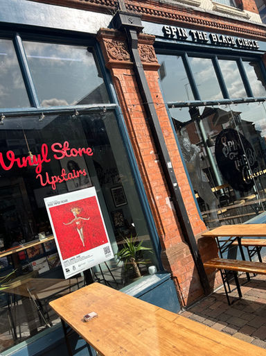 Image shows last years winning Lights, Camera...Paint poster in a cafe/bar window