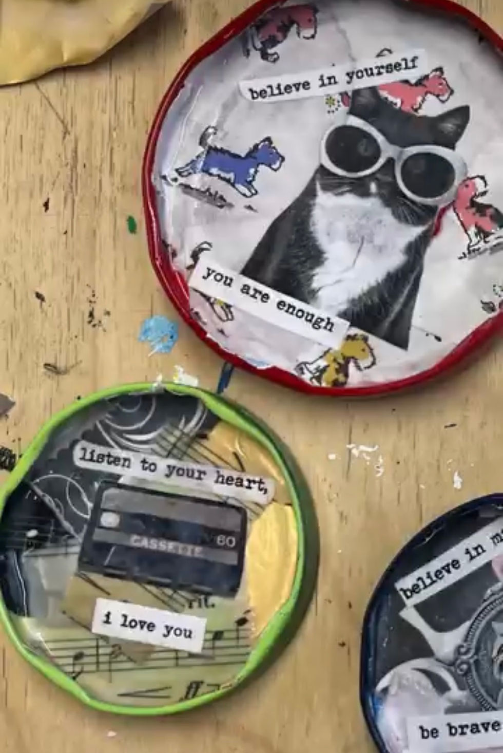 To people hands in a studio, rolling clay in to balls.