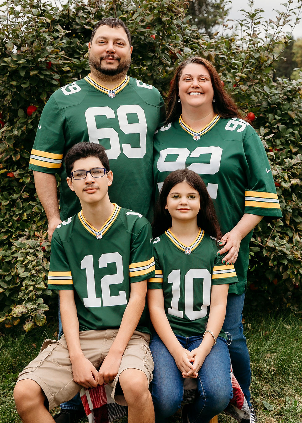 The Mendoza family, founders of Doza's Mobile Tavern, wearing Green Bay Packers jerseys in