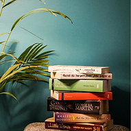 Stack of books against a green wall
