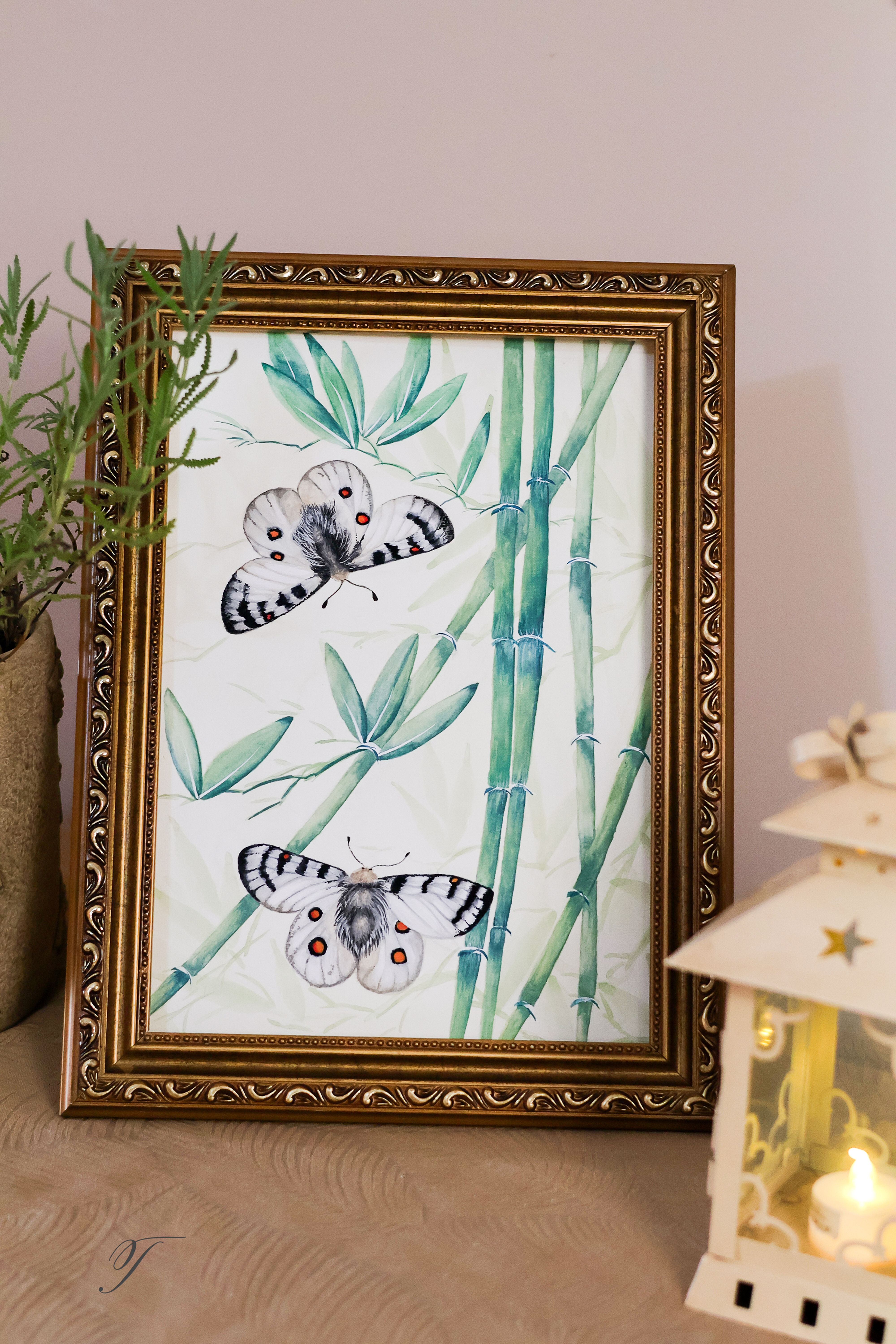 Gold-framed gouache chinoiserie painting featuring a bamboo forest with two Apollo butterflies fluttering around.