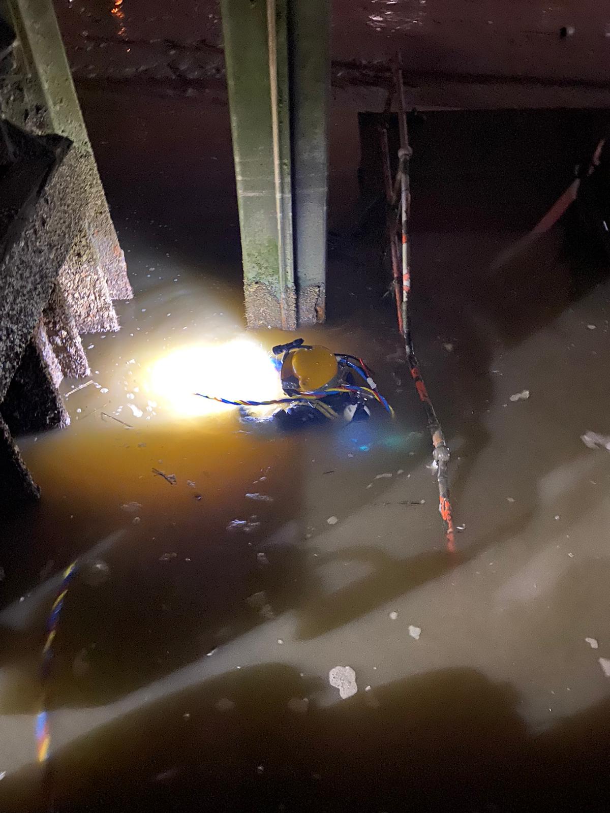 Murky floodwater with submerged debris and bright light