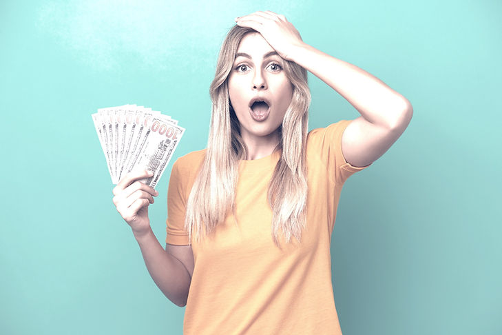 woman holding hand to head with money in her hand