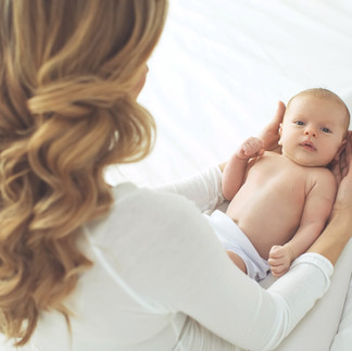 Mother holding and caring for a newborn baby