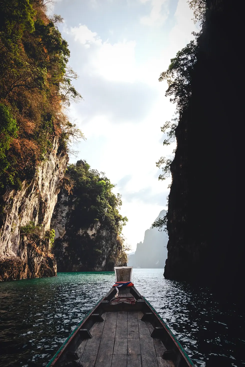 long-tail-boat-ride-limestone-islands-lake-against-sky.webp