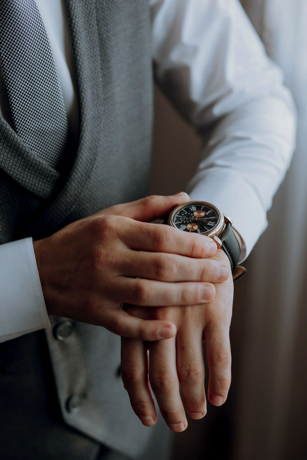 closeup-cropped-frame-man-puts-watch-with-leather-belt-is-dressed-stylish-suit-white-shirt