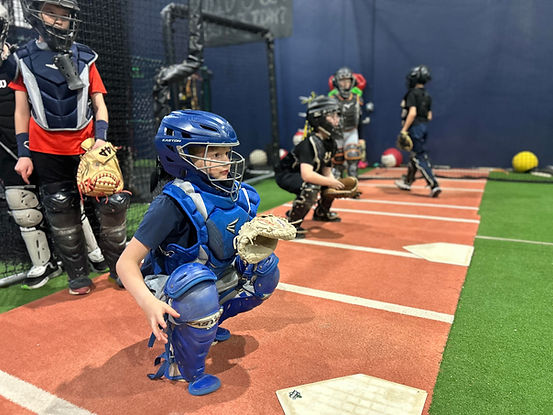 youth baseball players are doing drills during an indoor camp