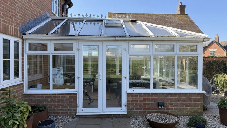 The original white conservatory with an ageing glazed roof before Concept Glazing's work