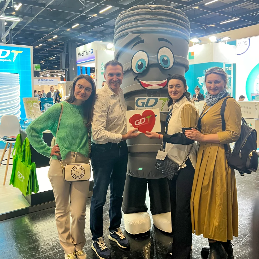 Dentist group posing and hugging with smilix next to the GDT Booth - IDS Cologne 2025