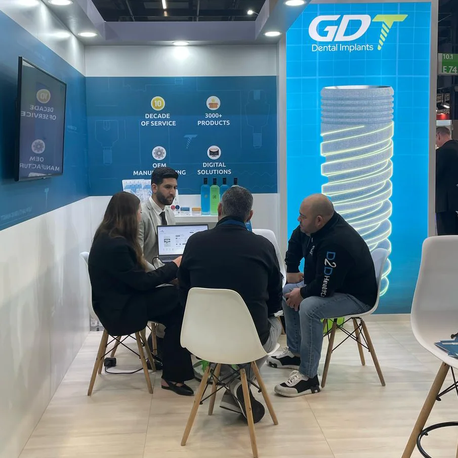 Yakir and Alona sitting with clients at the GDT booth - IDS Cologne 2025