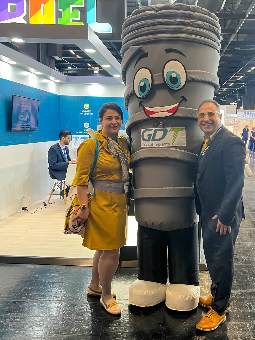 Dentist client and his wife posing with Smilix infront of the GDT booth - IDS Cologne 2025