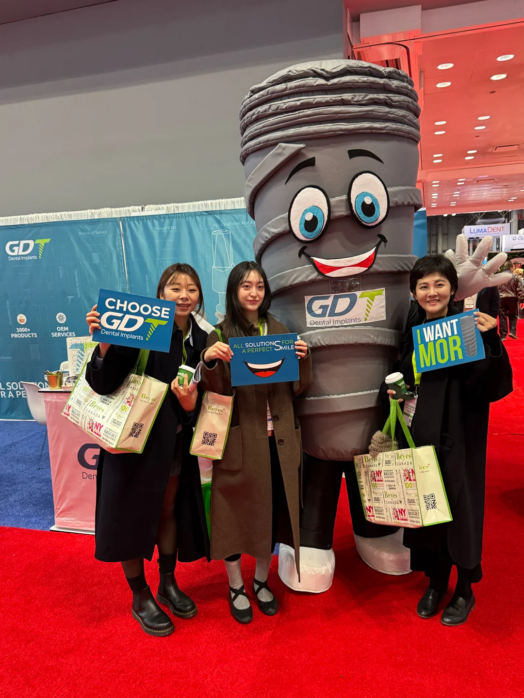GDT Dental Implants mascot with clients at GNYDM 2024