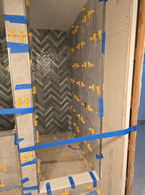 Herringbone shower tile installation in Pinellas County bathroom remodel
