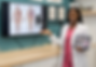 a woman instructor pointing towards a screen displaying an image of human anatomy
