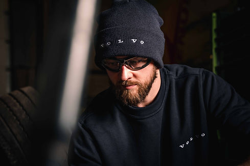Man wearing protective goggles and a Volvo beanie