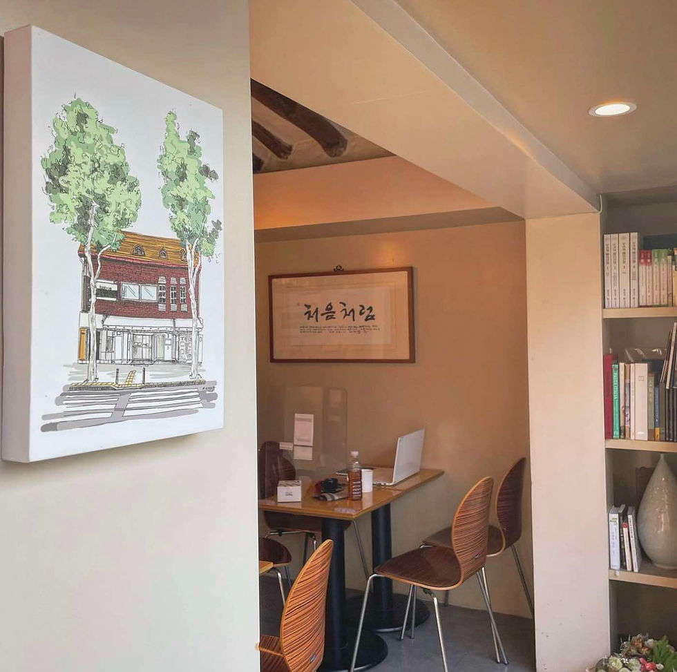 a painting on wall and seats on a korean cafe