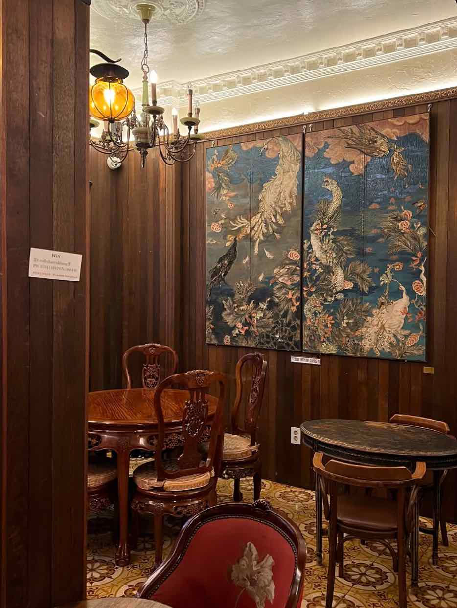 vintage cafe with historic table and chairs, painting on the wall