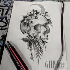 A graphite pencil sketchbook drawing of a tattoo design featuring a human skull adorned with flowers and vines, created by Gail Perry GHPthree. Additionally, a crescent moon is depicted behind the skull.