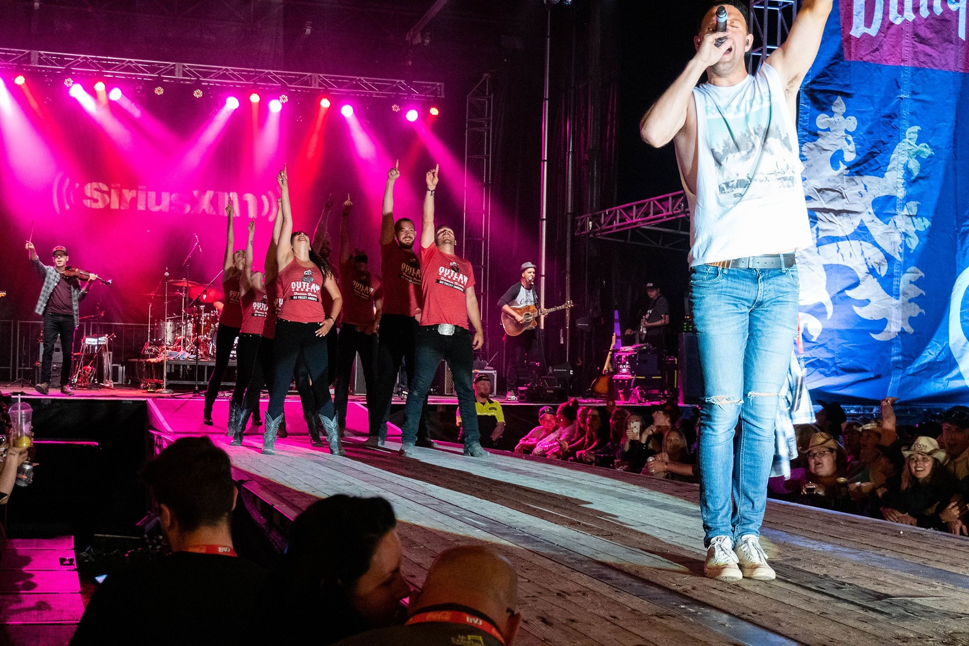 Professional country swing dancers finishing a performance on the Coors Banquet stage at Big Valley Jamboree while backing country artist Dan Davidson, showcasing stage-ready modern country dance performance.