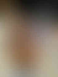 girl walking in sandy streets of downtown Holbox, Mexico kissing a marquesita