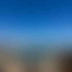 people laying on towels and swimming in the natural pools at Porto Moniz in Madeira Portugal