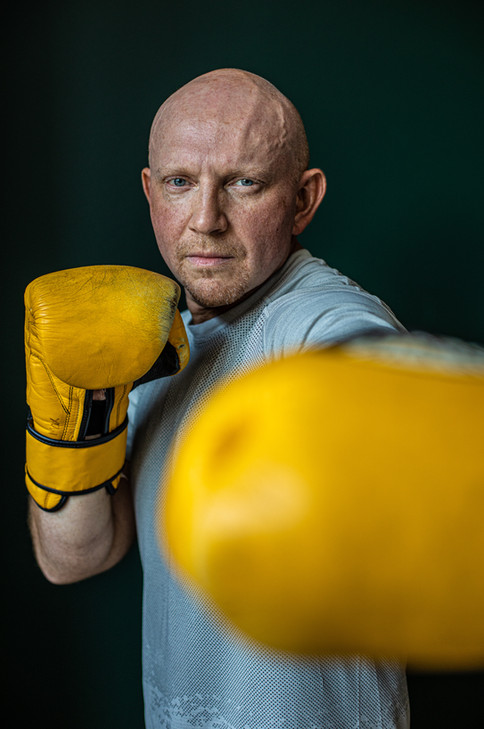nyc headshot photographer with yellow boxing gloves