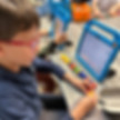 Sinai Learning Lab student solving math problems using counting blocks and a tablet.