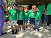 Children wearing green Gan Sinai shirts smiling with their arms around each other outdoors at Temple Sinai’s vacation camp, highlighting a joyful early childhood camp experience for ages 18 months through elementary school.