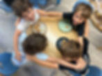 Students working together around a large table during a collaborative, project-based learning activity at Sinai Learning Lab.