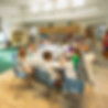 Students working together around a large table during a collaborative, project-based learning activity at Sinai Learning Lab.