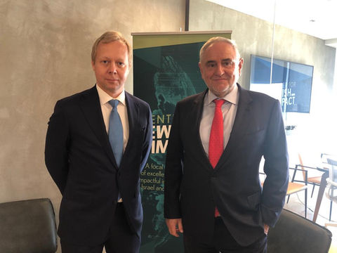 Two men in suits facing the camera.