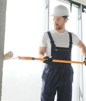 worker-renewing-apartment-on-wall-background-2023-11-27-05-34-16-utc_edited.jpg