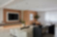 Bespoke oak-clad media wall, office desk, and bathroom vanity unit in a modern living room.