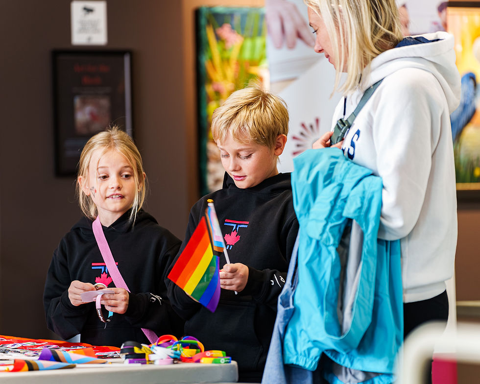 Children engaging with a rainbow flag at a Rainbow Resources event