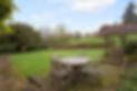 Outdoor seating area overlooking garden at mount Farm Bed and Breakfast