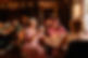 Ladies sitting at a table chatting animatedly and having drinks