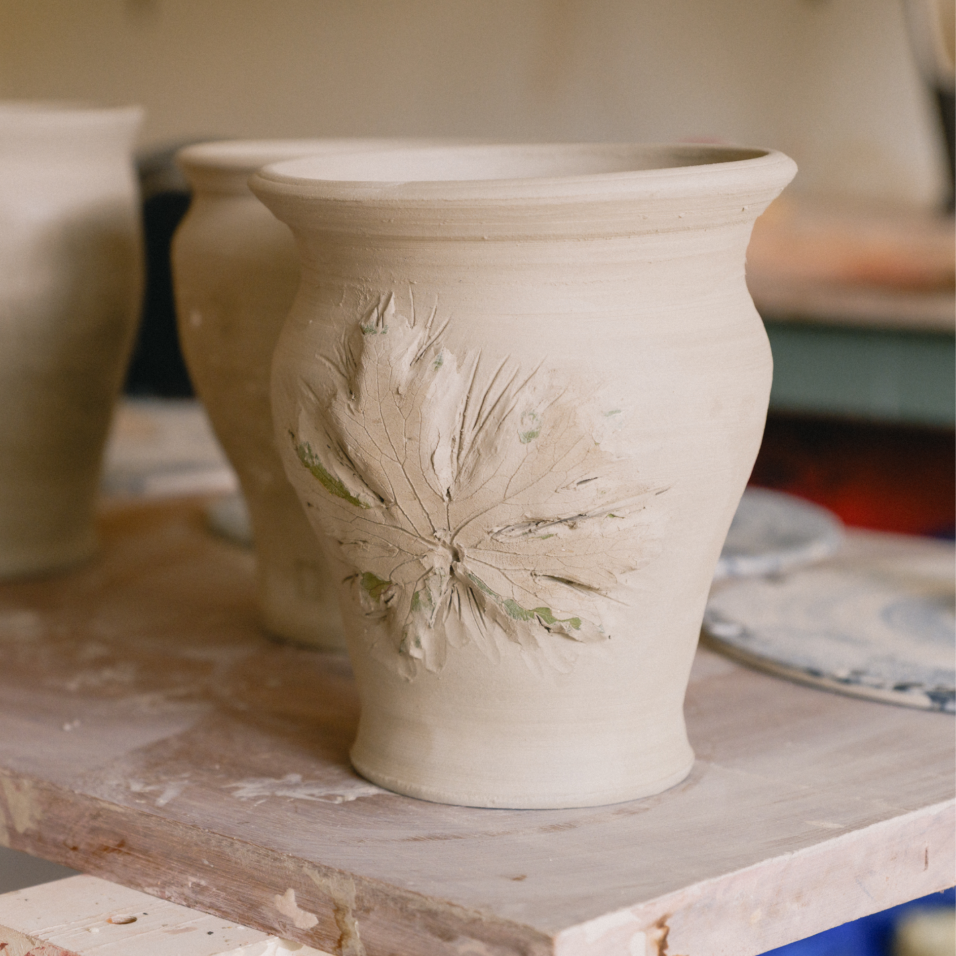Pelargonium leaf design pressed on to front of hand made flower pot