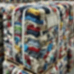 DALL·E 2024-10-18 21.55.49 - A close-up view of recycled textile bales, showing compressed