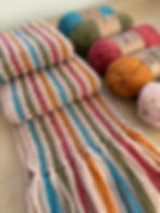 colourful crochet scarf and yarn
