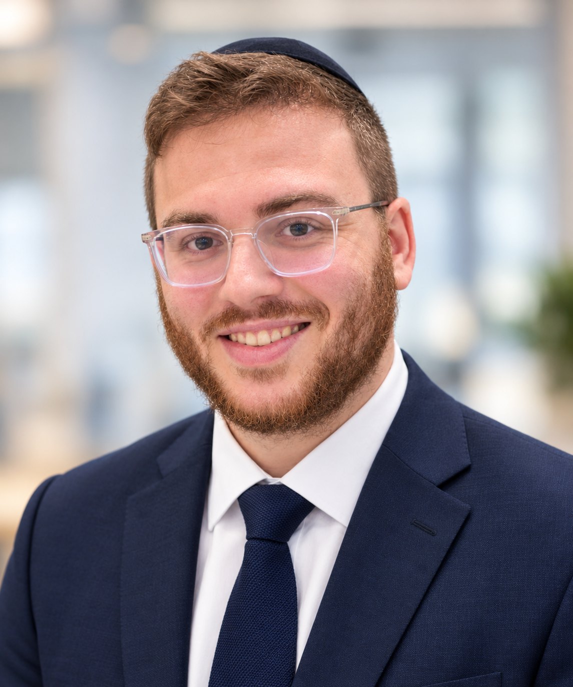 Mendel Meroz, CPA, in a navy suit and clear-framed glasses