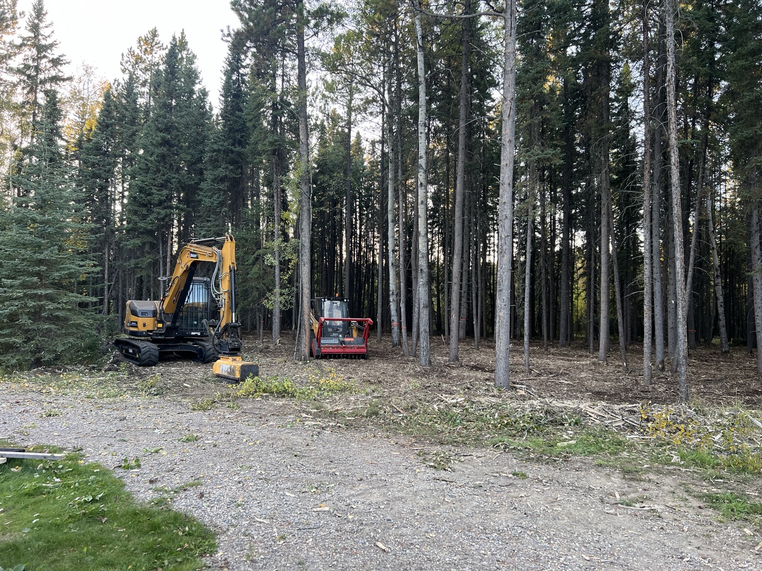 Skid steer and excavator mulchers working together