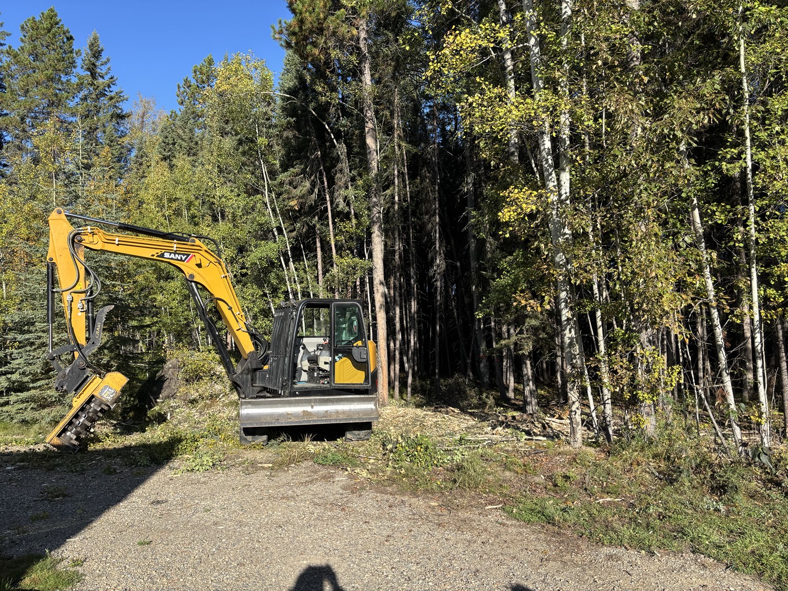 Excavator mulching for selective woodland clearing